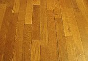Wood can be cut into straight planks and made into a hardwood floor (parquetry).